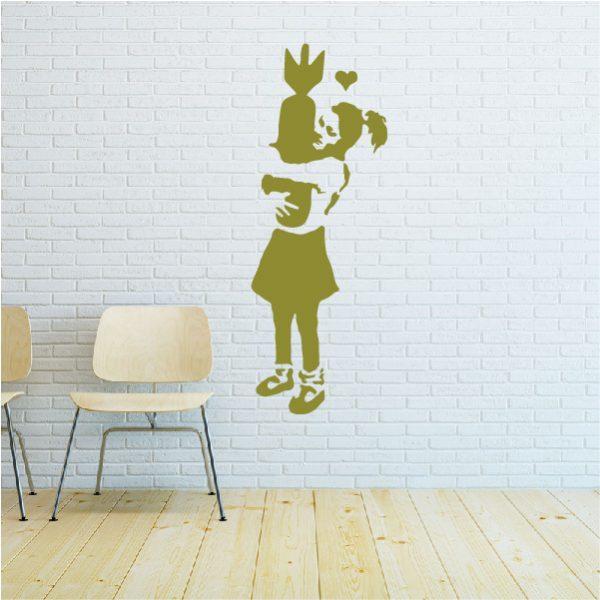Girl with Bomb. Banksy's graffiti. Wall sticker. Gold